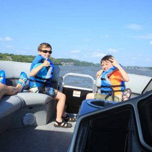 a group of people sitting around a car