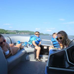 a group of people sitting around a car