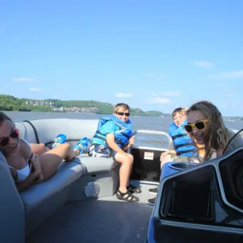 a group of people sitting around a car