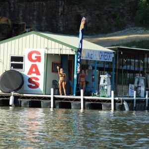 a group of people sitting at a dock