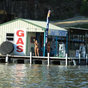 a group of people sitting at a dock