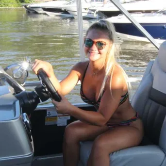 a woman sitting in a boat on the seat of a car
