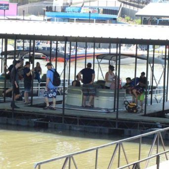 a group of people sitting at a dock