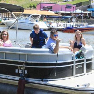 a group of people in a small boat in a body of water