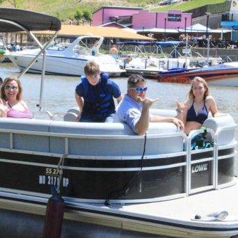 a group of people in a small boat in a body of water