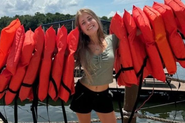 a woman standing in front of a beach