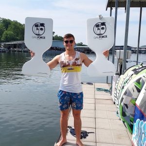 Person at boat rental dock holding water saddles