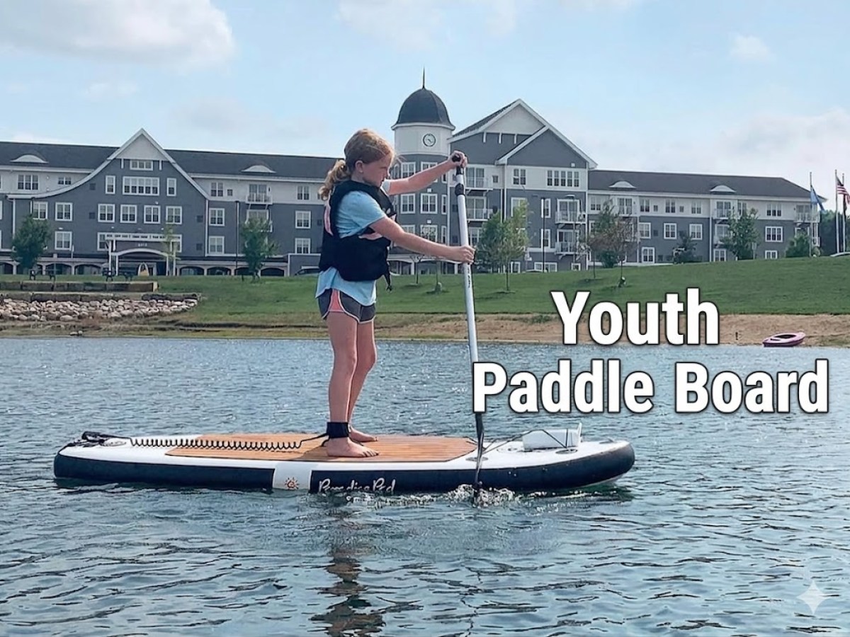 Child paddle boarding on a lake near a large building, text reads 'Youth Paddle Board.'